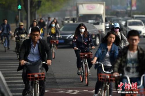 资料图：2017年4月17日，北京迎来沙尘天气市区能见度降低，市民佩戴口罩出行。 中新网记者 金硕 摄