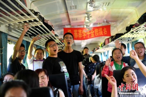 资料图:2017年6月5日,乘坐“高考专列”的学生在车厢内集体加油助威。中新社记者 王舒 摄
