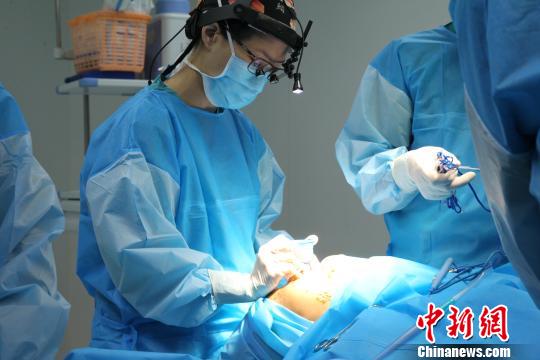 图为医生正在为患者手术。 张海雯 摄