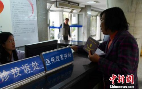 资料图:一名女子在医保政策咨询台前咨询。王思哲 摄