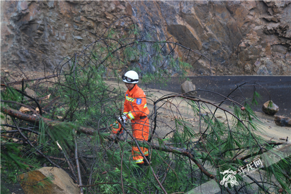 山体滑坡致十余汽车被困 万州消防徒手搬石恢复交通