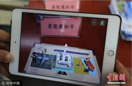 通知书的主人是来自山东的魏某某同学。与往年不同的是,西北工业大学在每一份录取通知书中嵌入了基于AR技术的虚拟校园平台。图片来源:视觉中国 通知书的主人是来自山东的魏某某同学。与往年不同的是,西北工业大学在每一份录取通知书中嵌入了基于AR技术的虚拟校园平台。图片来源:视觉中国