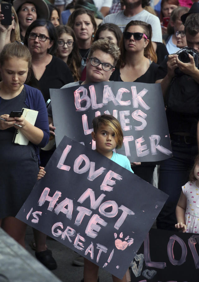  8月14日，在美国盐湖城，人们手持标语参加抗议。（新华/美联）