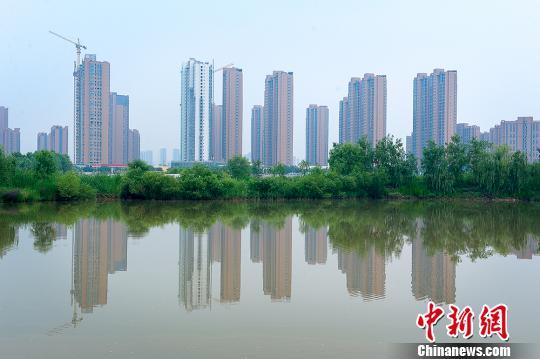 兰州新区打造“多湖水城、生态绿城”,从“引大入秦工程”取水构建人工水系,知足周边农田浇灌及南北两山绿化用水。图为远望生涯区一角。(资料图) 钟欣 摄