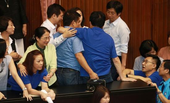 “蓝绿”双方爆发推挤后，民进党团随即抢回主席台。（图片来源：台湾联合新闻网）
