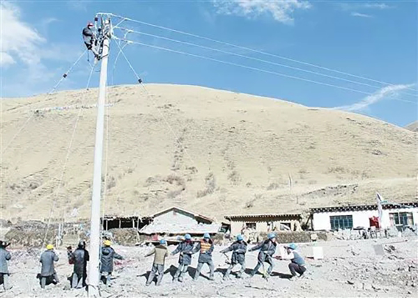 国家电网员工在青海藏族居民家门口架设电线。  经济日报 图