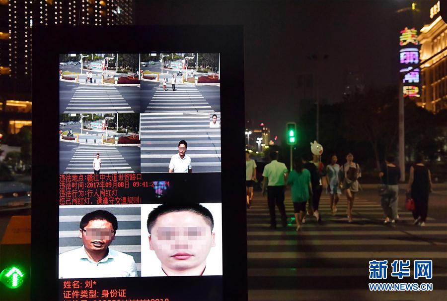 在南昌市红谷滩新区赣江中大道与世贸路交叉路口，南昌市公安交管局安装的“行人闯红灯人脸对比”系统曝光抓拍的闯红灯行人及经过处理的身份信息（9月13日摄）。