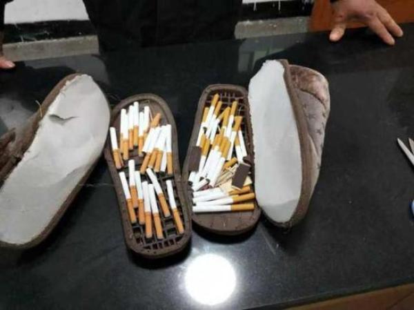 天气转热为何给在拘人员送棉鞋:鞋底藏烟(图)