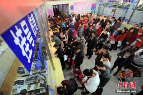 资料图：民众在医院排队挂号、交费。中新社发 韦亮 摄