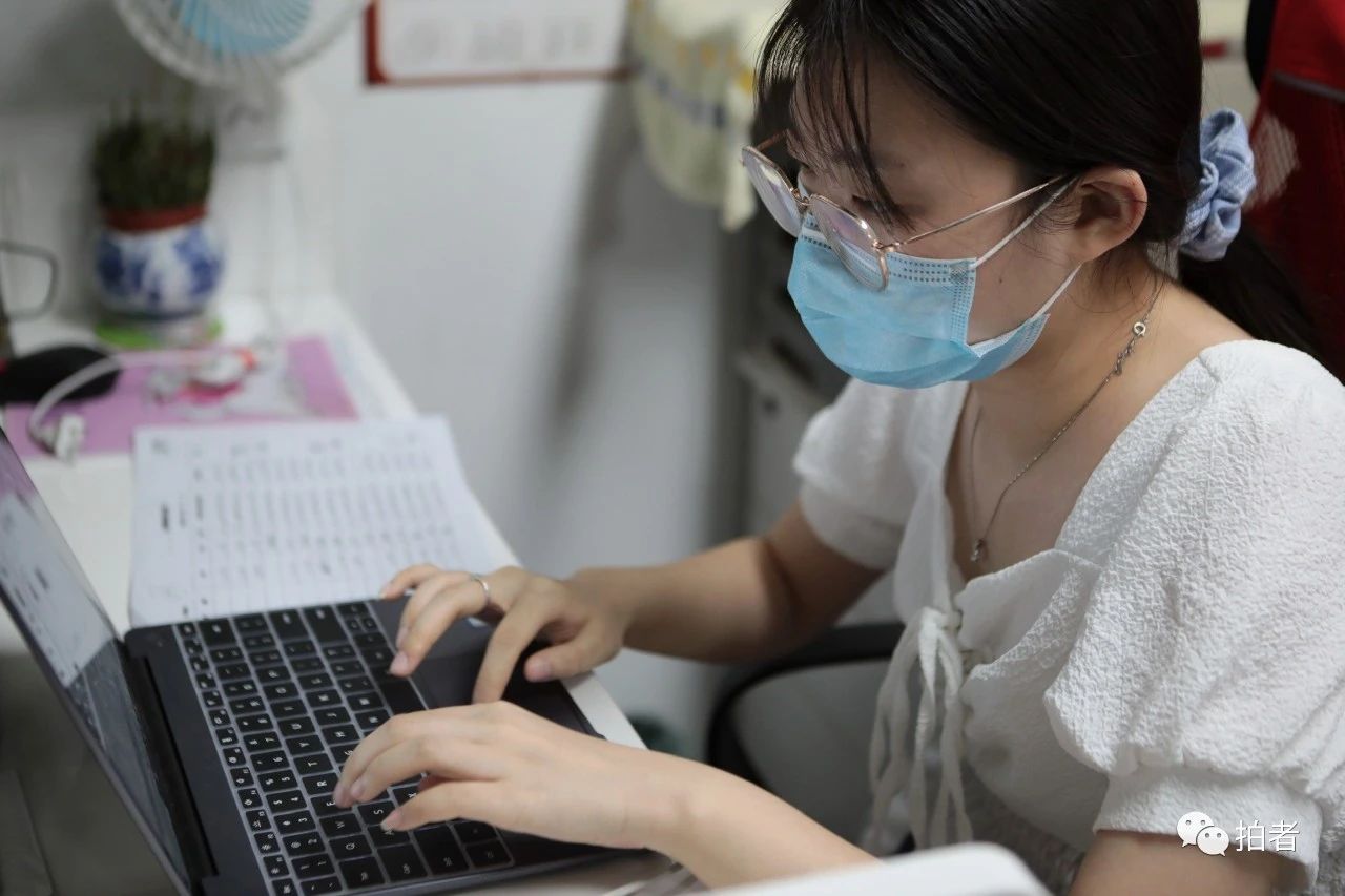 △6月20日,社区服务站内,尚未开学的大学生缪雨瞳在整理居民核酸检测数据。
