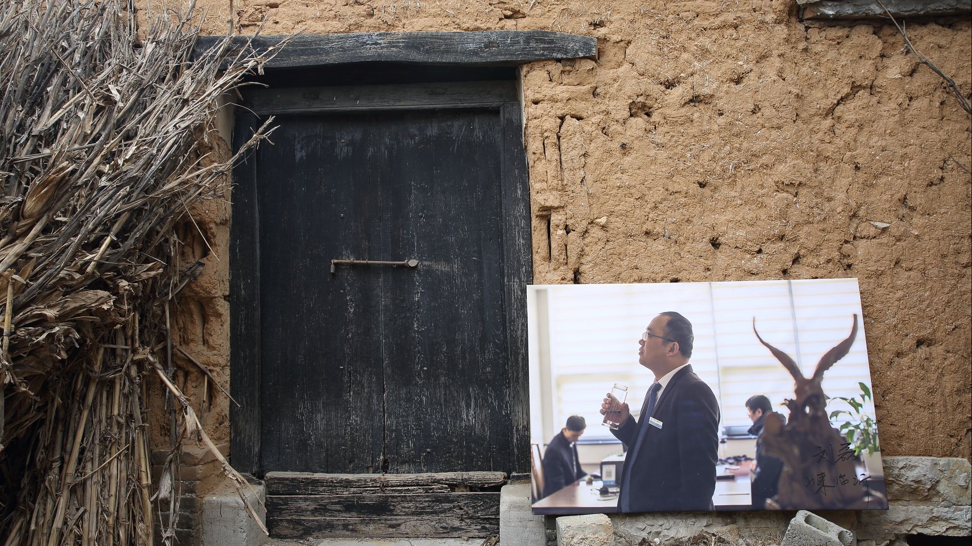潘庄村人刘磊在山东临沂市某公司做职员，老家已多年无人居住。2019年2月18日，摄影师刘磊（两人同名）将其在城市工作的照片，摆放在老家门前展出。受访者供图