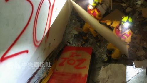 花莲云门翠堤大楼内仍有一名大陆游客遗体被大梁压住而未能移出、一名大陆游客遗体仍未发现。征得家属同意,11日中午起改以机具开挖,搜救人员先以毛毯及木板覆盖遗体防止受到破坏。图片来源:“中央社”