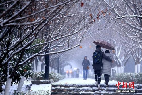 1月3日,西安迎来今年的第一场降雪,纷飞的雪花使整个古城“银装素裹”,当地民众乐赏美丽雪景。王晓凯 摄