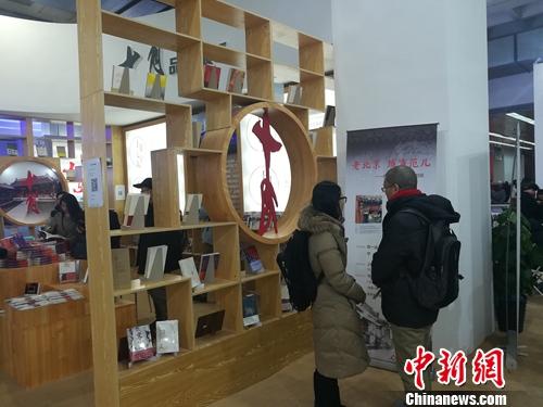 北京十月文艺出版社展台前，两名读者正兴致勃勃讨论陈列的书籍。据该社总编辑韩敬群透露，目前该社对电子书版权也十分重视。上官云 摄