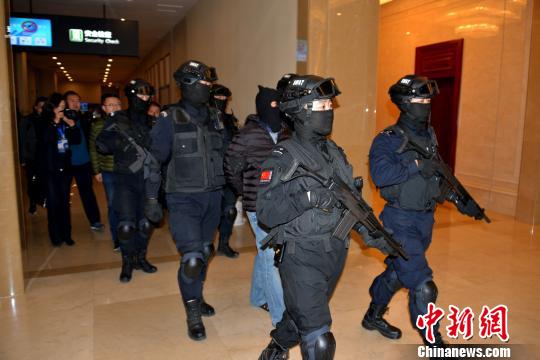 图为12月8日晚,“红通”逃犯杨国庆被兰州警方押解返回兰州。 魏存武 摄