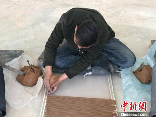 图为工人席地而坐,制作藏香。 王立林 摄