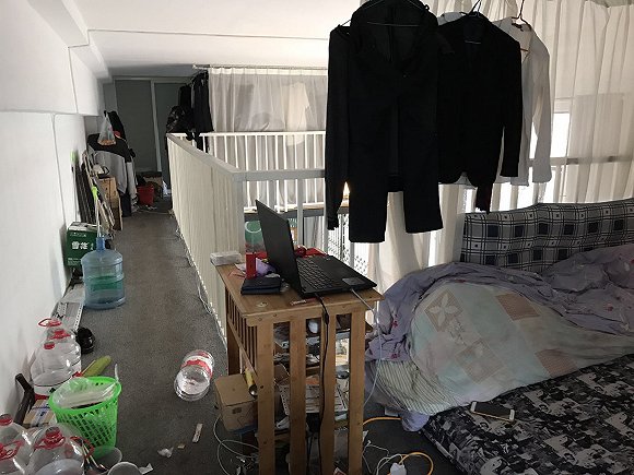 上面住宿，下面是包裹操作区，主管平时在床边的电脑工作。摄影：习曼琳