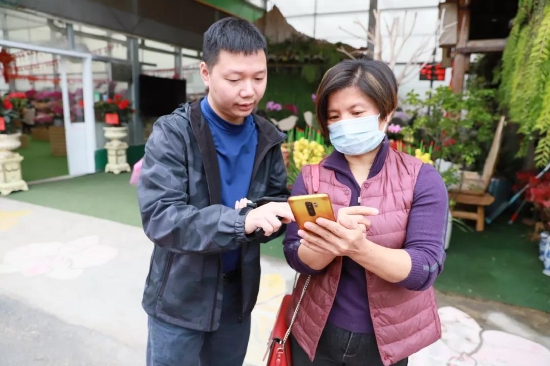 来自桂城花店的陈小姐来此批量购买蝴蝶兰,拿回去桂城售卖。现场得知有活动的她,当即抽中了50元年花消费券。