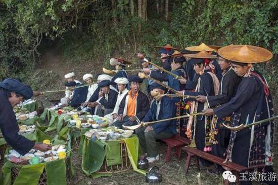 盛装青年男子向“咪谷”祈求祭献过神灵的食物 他们相信吃过这些食物后可以丰衣足食