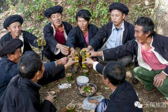 族人中的“咪谷”在神树林中分享祭品 “咪谷”是配合“摩批”举行祭祀的人员