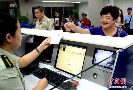 资料图:台胞在福州机场边检站办理办理入境手续时免签注,经过人像对照和核查证件有效无异常后顺利通关。 中新社发 刘可耕 摄