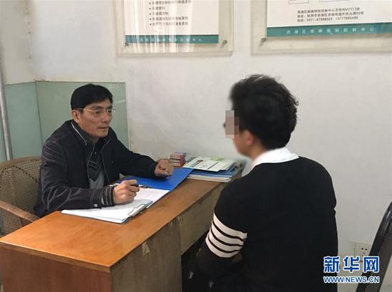 刘建宁在杭州市西湖区疾病预防控制中心自愿咨询检测室接受咨询(资料照片)。 新华社发