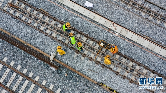 中老铁路勐松二号隧道附近,铁路建设者正在进行轨道精调