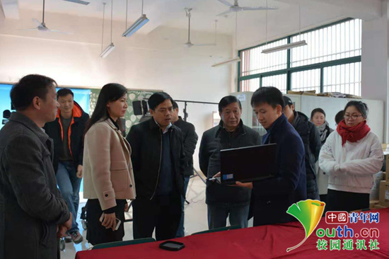 图为安徽大学艺术与传媒学院汪博(前排右一)在为老师介绍校媒作品。本人供图