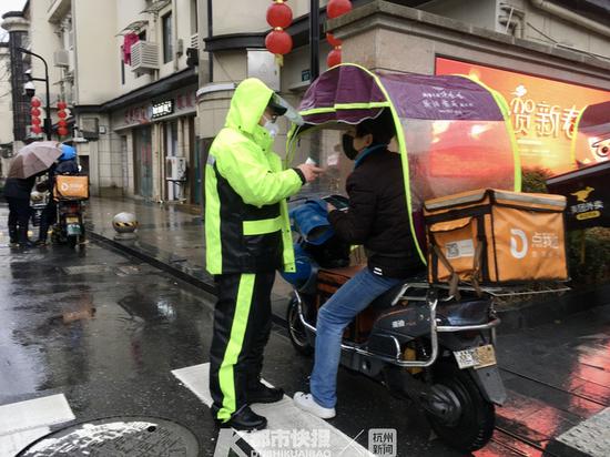 一些小区物业开始给外卖小哥测体温 　　摄影 | 朱文科