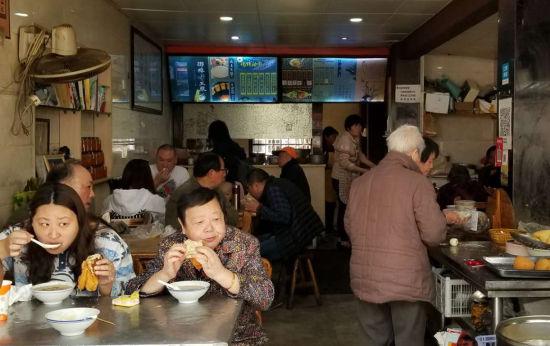 图为:尽管在中午时分,该早餐店仍有不少顾客。 王刚 摄