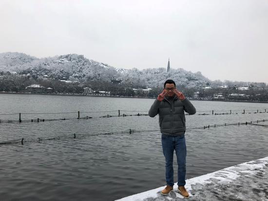 (2018年杭州初雪,方闽男在西湖边留影。)
