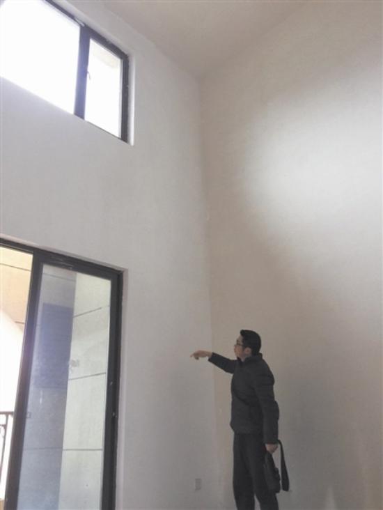 连先生在指认漏水的墙体