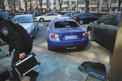 昨日，丰台政馨园二区7辆轿车车窗被砸，车内物资遭盗窃。公安人员在现场取证。新京报记者 彭子洋 摄