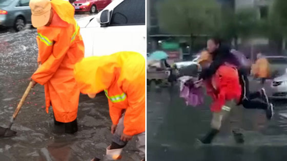大雨路面积水 环卫工人背女学生过马路