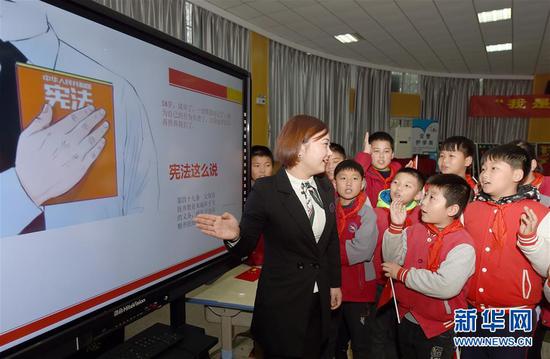 安徽省合肥市经开区明珠居委会法律援助律师在给明珠小学的学生们讲解宪法知识(2018年12月3日摄)。 新华社记者 郭晨 摄
