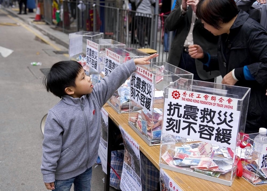 2010年4月17日，一名小朋友在香港工会联合会的募捐点捐款。当日，香港工会联合会在香港设置3处筹募点，为青海玉树地震灾区筹募善款。新华社记者陈铎摄