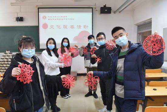 2月4日，北方“小年”，河北大学留校学生与老师一起剪窗花。 郭占欣 摄