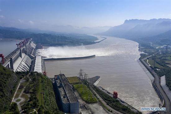 Aerial photo taken on Aug. 2, 2020 shows water gushing out from the Three Gorges Dam in central China's Hubei Province. According to the Changjiang Water Resources Commission of the Ministry of Water Resources, reservoirs along the upper and middle reaches of Yangtze River, including the Three Gorges Dam and the Gezhou Dam, have held back over 30 billion cubic meters of floodwater since July this year. (Xinhua/Du Huaju)