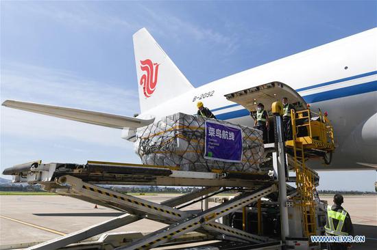 Staff members load the commodities onto a cargo airplane at the Hangzhou Xiaoshan International Airport in Hangzhou, east China's Zhejiang Province, Aug. 13, 2020. An all-cargo air route linking China's Hangzhou and Spain's Madrid was launched Thursday. The route, operated three times a week by Air China Cargo, is expected to more than half the shipping time of foreign trade commodities to about 10 days. (Xinhua/Huang Zongzhi)