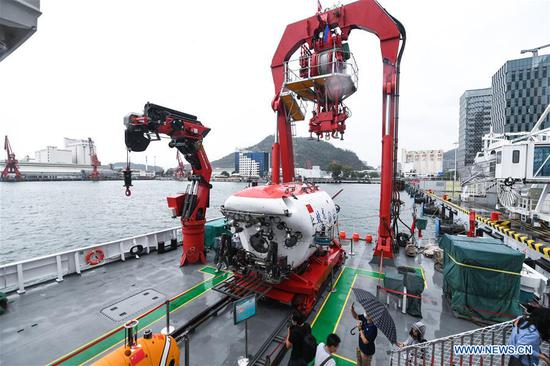  Journalists take photos of the manned submersible Jiaolong on its mothership Shenhai Yihao (DeepSea No. 1) at a port in Shenzhen, south China's Guangdong Province, Oct. 13, 2020. The manned submersible Jiaolong, its mothership Shenhai Yihao (DeepSea No. 1), and dredging vessel Tian Kun Hao will be displayed during the China Marine Economy Expo (CMEE). (Xinhua/Mao Siqian)