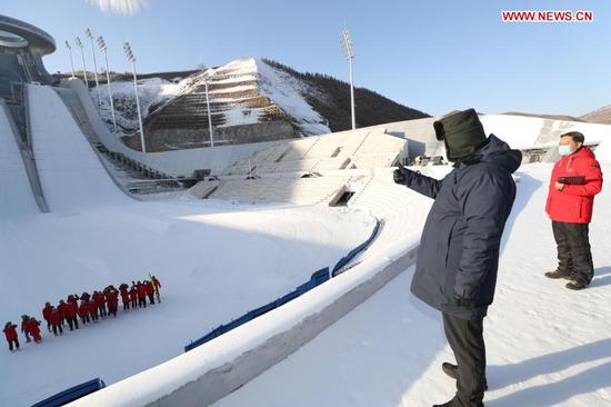Chinese President Xi Jinping, also general secretary of the Communist Party of China Central Committee and chairman of the Central Military Commission, extends greetings to athletes and coaches at the National Ski Jumping Center in Zhangjiakou, north China's Hebei Province, Jan. 19, 2021. Xi on Tuesday arrived in Zhangjiakou by taking the Beijing-Zhangjiakou high-speed rail. He inspected the Taizicheng rail station close to the competition venues and athletes' village of the Beijing 2022 Olympic and Paralympic Winter Games, the National Ski Jumping Center, and the National Biathlon Center. (Xinhua/Wang Ye)
