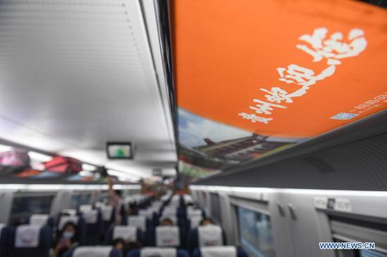 A sign that reads "Welcome to Guizhou" is seen inside a high-speed passenger train car at the Shenzhen north railway station in Shenzhen, south China's Guangdong Province, March 16, 2021. High-speed passenger train No. G6022, officially dubbed "Romantic Season of Blossoms in Colorful Guizhou," set off from the Shenzhen north railway station on Tuesday. This move was to encourage residents in Shenzhen and Guizhou to visit the other place. (Xinhua/Mao Siqian)