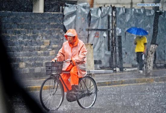 A man cycles amid a downpour in Benxi, northeast China's Liaoning Province, Aug. 27, 2020. Typhoon Bavi, the eighth of this year, brought gales and rainstorms to cities in northeast China. (Photo by Lin Lin/Xinhua)