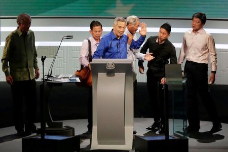 Singapore's Prime Minister Lee Hsien Loong is helped off the stage after taking ill during his National Day rally speech in Singapore August 21, 2016.