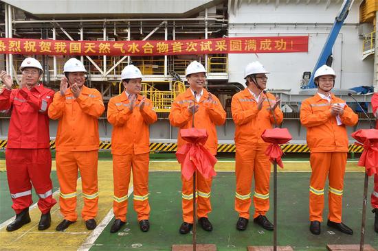 Chinese Minister of Land and Resources Jiang Daming (3rd R) announces the success in trial mining of combustible ice at sea, on a trial mining site in the Shenhu area of the South China Sea, May 18, 2017. China has succeeded in collecting samples of combustible ice in the South China Sea, a major breakthrough that may lead to a global energy revolution, Minister of Land and Resources Jiang Daming said Thursday. (Xinhua/Liang Xu)