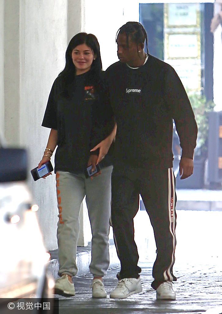 组图:凯莉·詹娜运动装遮肚显"孕味" 与"老公"同行挽手热聊