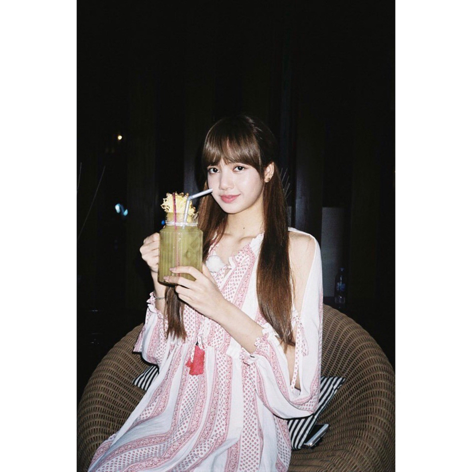 新浪娱乐讯 女团blackpink官方账号曝光lisa新照,绿色背景及插花营造