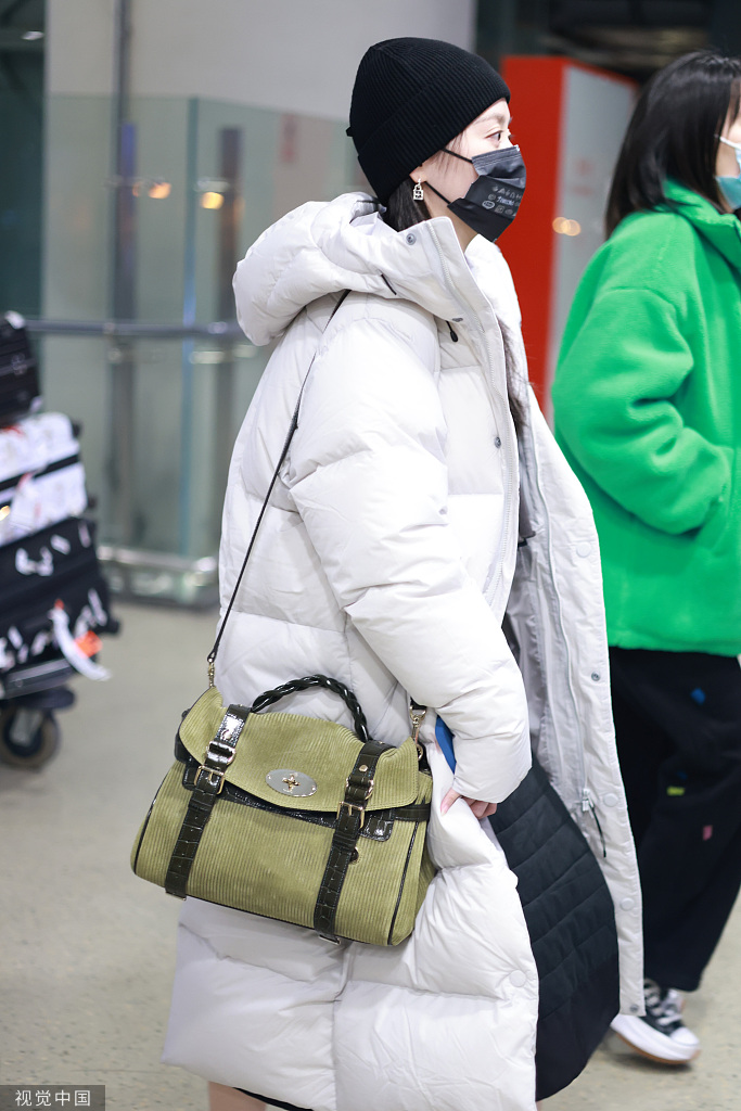 组图:张靓颖着白色羽绒服现身机场 军绿包包配黑色内搭时尚温暖