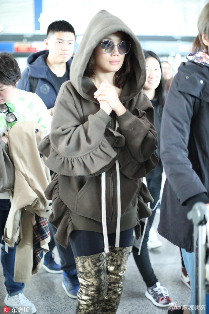 组图:容祖儿现身机场造型吸睛 荷叶袖卫衣搭金棕色长筒靴