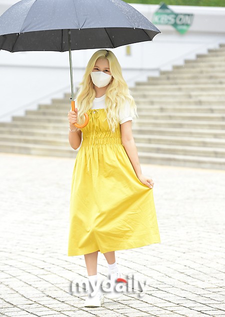 組圖：宇宙少女任多榮穿黃裙色彩明豔 雨中撐傘去上班